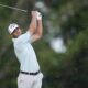 Burns fires 65 to grab U.S. Open lead as heavy rain spoils play