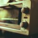 Why do microwave ovens sometimes overheat water?